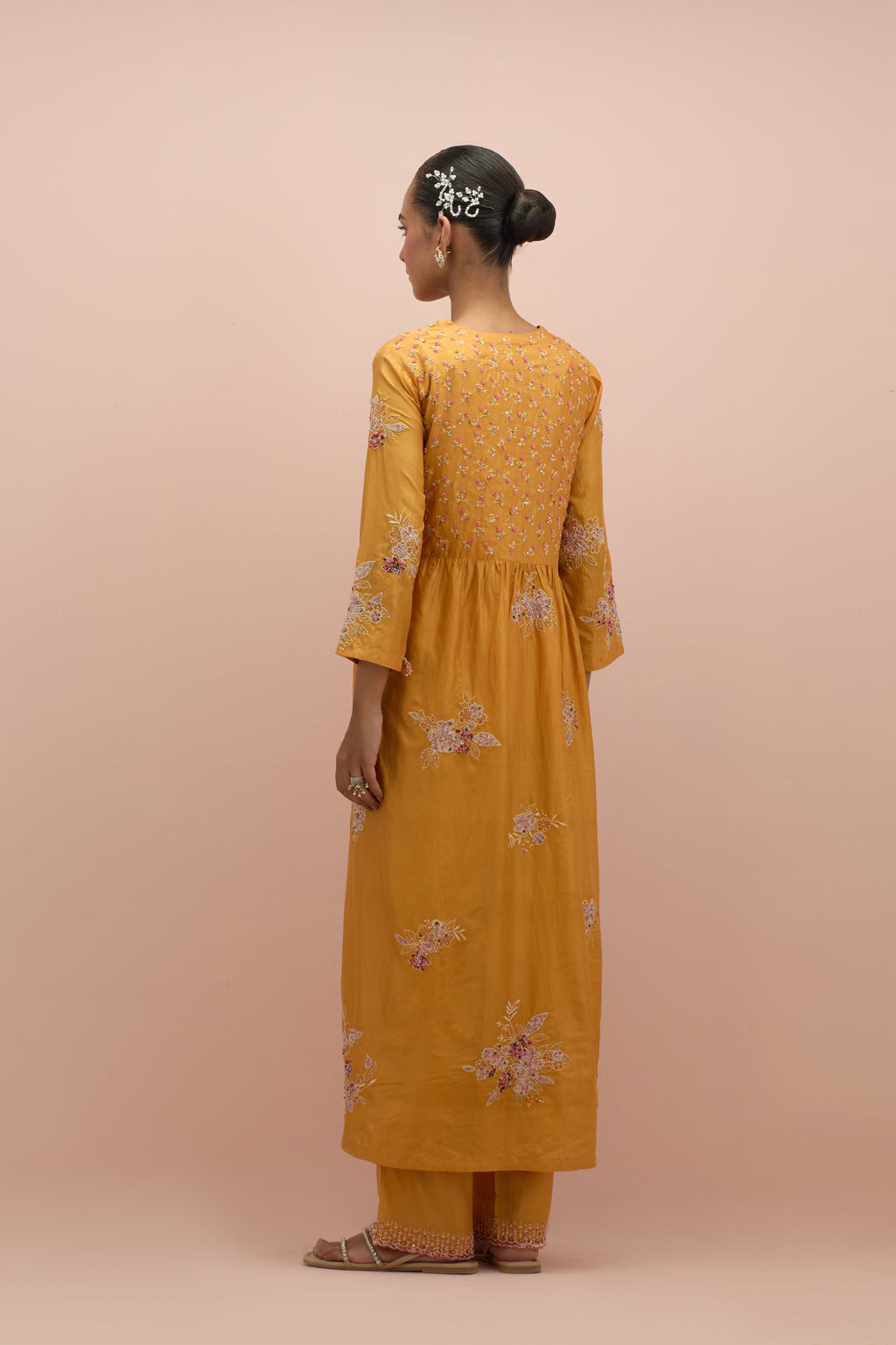 Amber silk kurta dress set with delicate embroidered flowers and hand block printed appliqué motifs, highlighted with sequins and multi-colored beads.