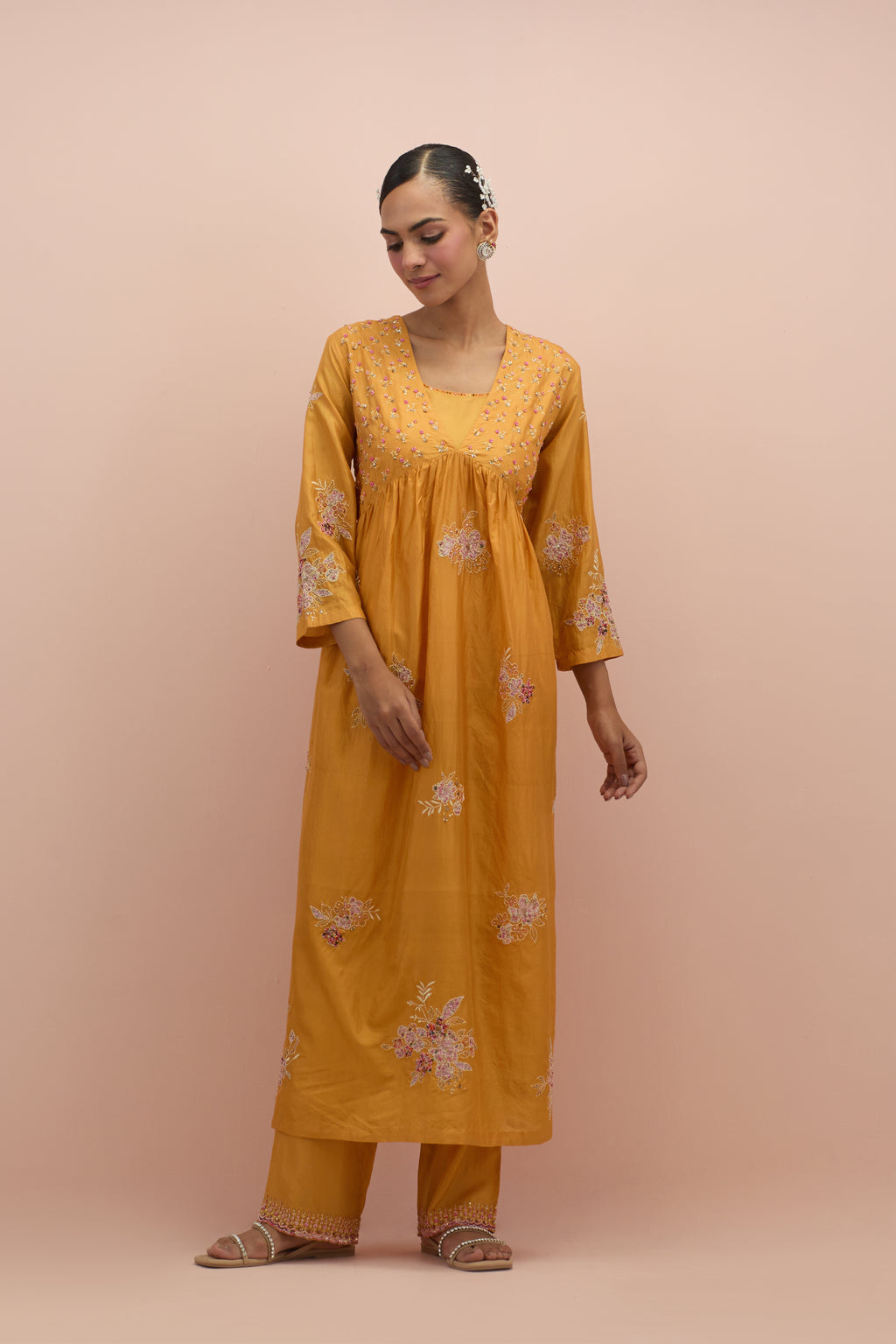 Amber silk kurta dress set with delicate embroidered flowers and hand block printed appliqué motifs, highlighted with sequins and multi-colored beads.