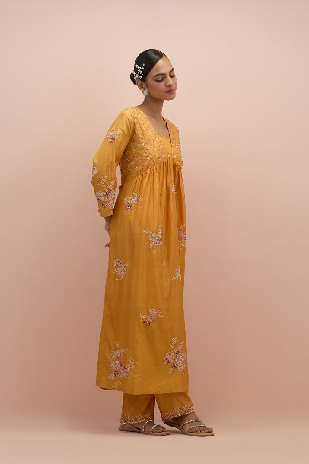 Amber silk kurta dress set with delicate embroidered flowers and hand block printed appliqué motifs, highlighted with sequins and multi-colored beads.