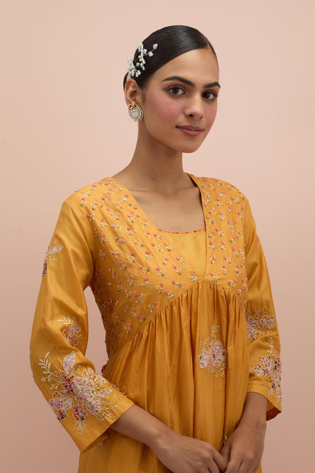 Amber silk kurta dress set with delicate embroidered flowers and hand block printed appliqué motifs, highlighted with sequins and multi-colored beads.