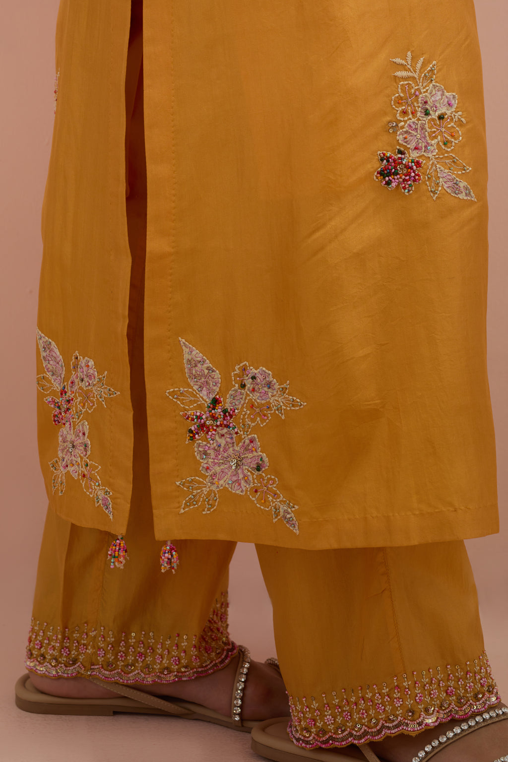 Amber straight kurta set with all-over delicate embroidered flowers, highlighted with sequins and multi-colored beads.