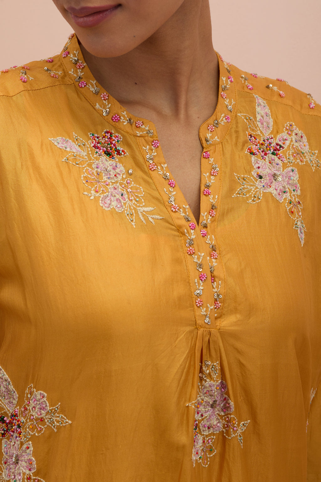 Amber straight kurta set with all-over delicate embroidered flowers, highlighted with sequins and multi-colored beads.