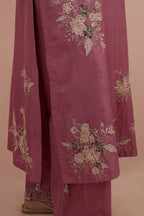 Salmon pink silk straight kurta set with randomly placed hand block printed appliquéd flowers, highlighted with sequins and multi-colored beads.