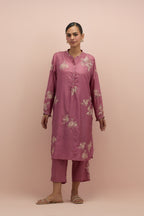Salmon pink silk short shirt kurta with all-over hand block printed appliqué, highlighted with sequins and multi colored beads, paired with Salmon pink silk ankle length straight pants with hand block printed appliqué motifs at the sides.
