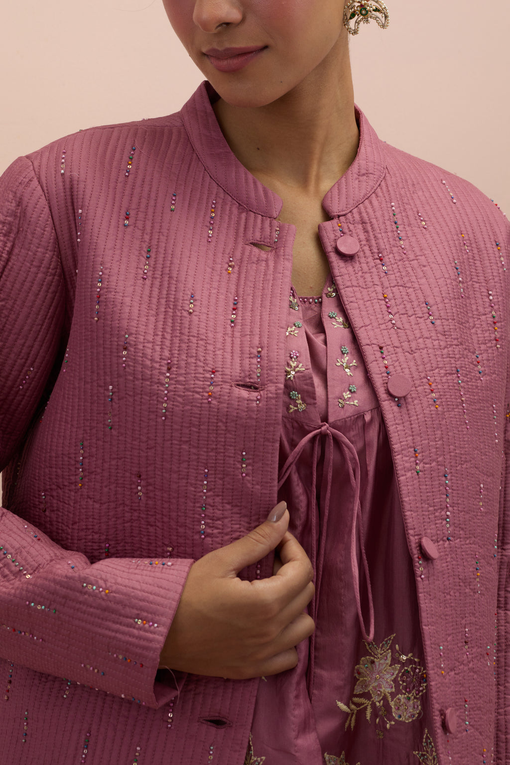 Salmon pink silk, quilted short length front open jacket set with all-over sequins and multicolored beads work.