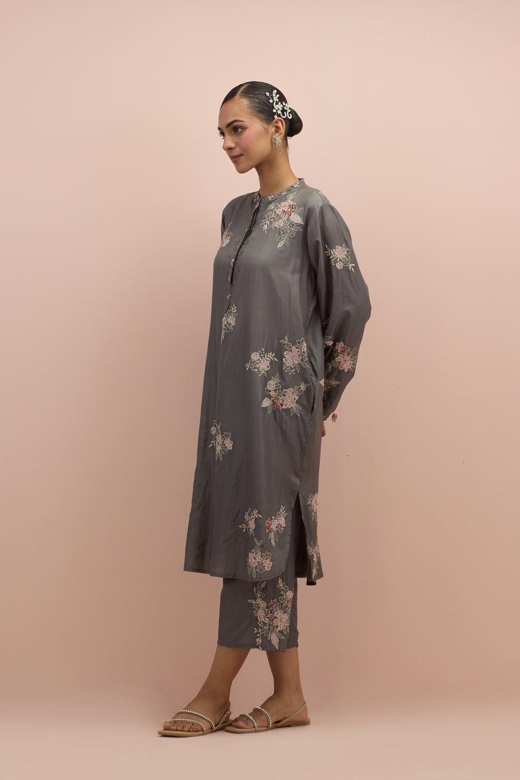 Iron grey silk short shirt kurta with all-over hand block printed appliqué, highlighted with sequins and multi colored beads, paired with iron grey silk ankle length straight pants with hand block printed appliqué motifs at the sides.