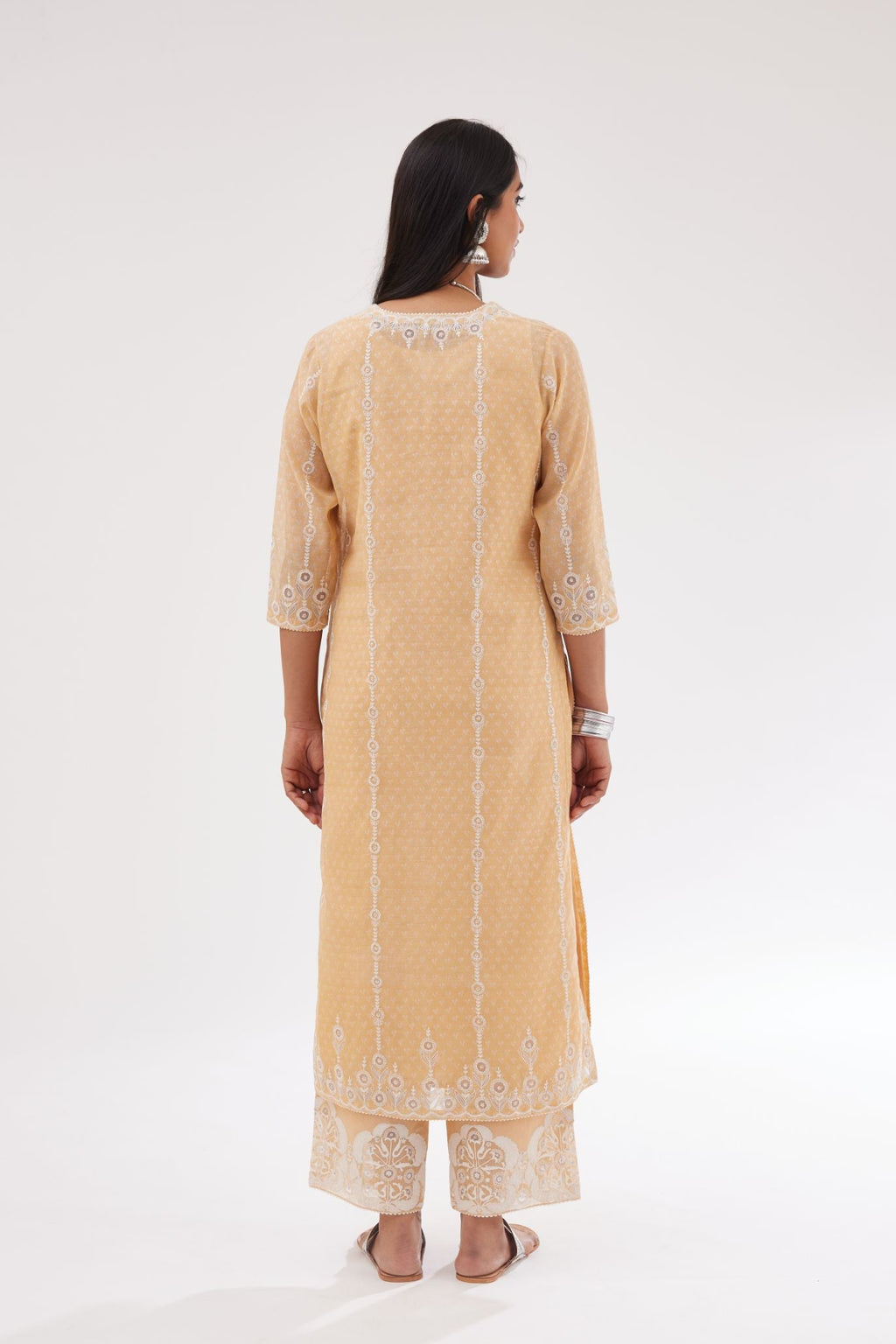 Peach cotton chanderi hand block printed kurta set with dori and silk thread chhari - stripes, all over and heavier butas at hem.