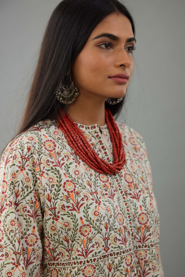 Red & green cotton short top with all-over hand block print, paired with blue and pink hand block printed cotton straight pants.