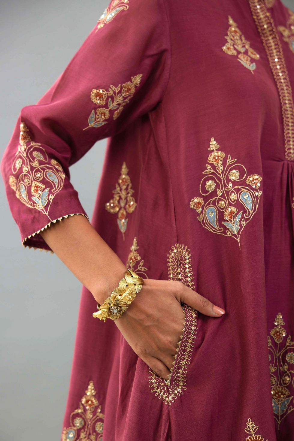 Wine Silk Chanderi short kurta set with collar and front placket, detailed with delicate gold embroidery is done around the placket and collar.