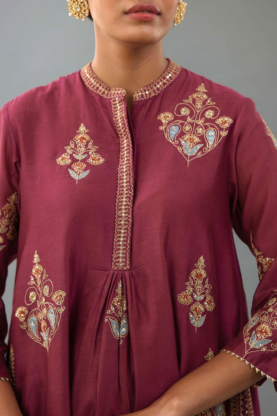 Wine Silk Chanderi short kurta set with collar and front placket, detailed with delicate gold embroidery is done around the placket and collar.