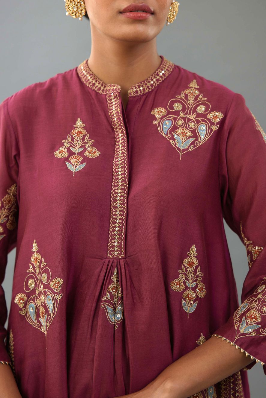 Wine Silk Chanderi short kurta with collar and front placket, detailed with delicate gold embroidery is done around the placket and collar.