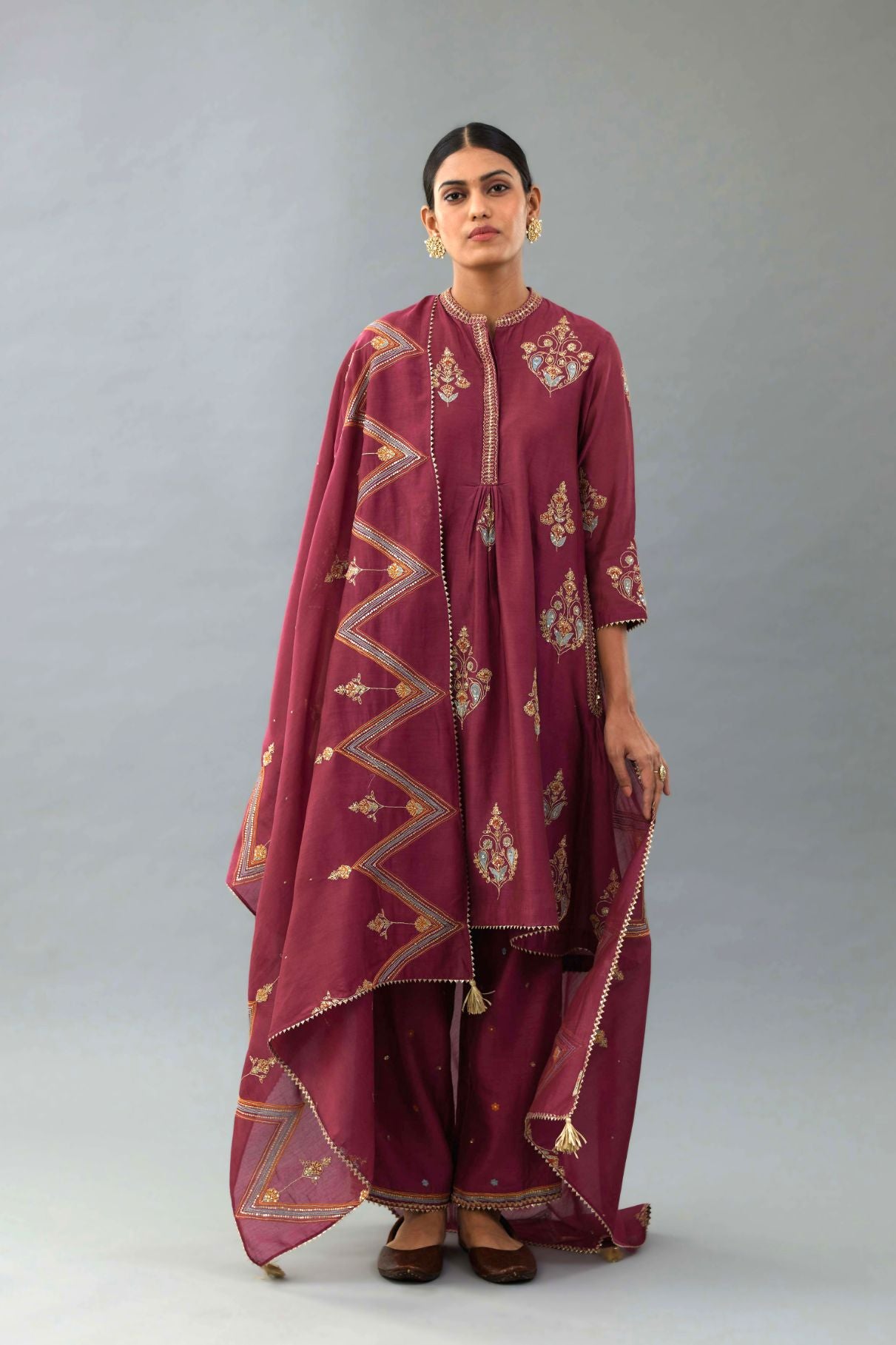 Wine Silk Chanderi short kurta set with collar and front placket, detailed with delicate gold embroidery is done around the placket and collar.