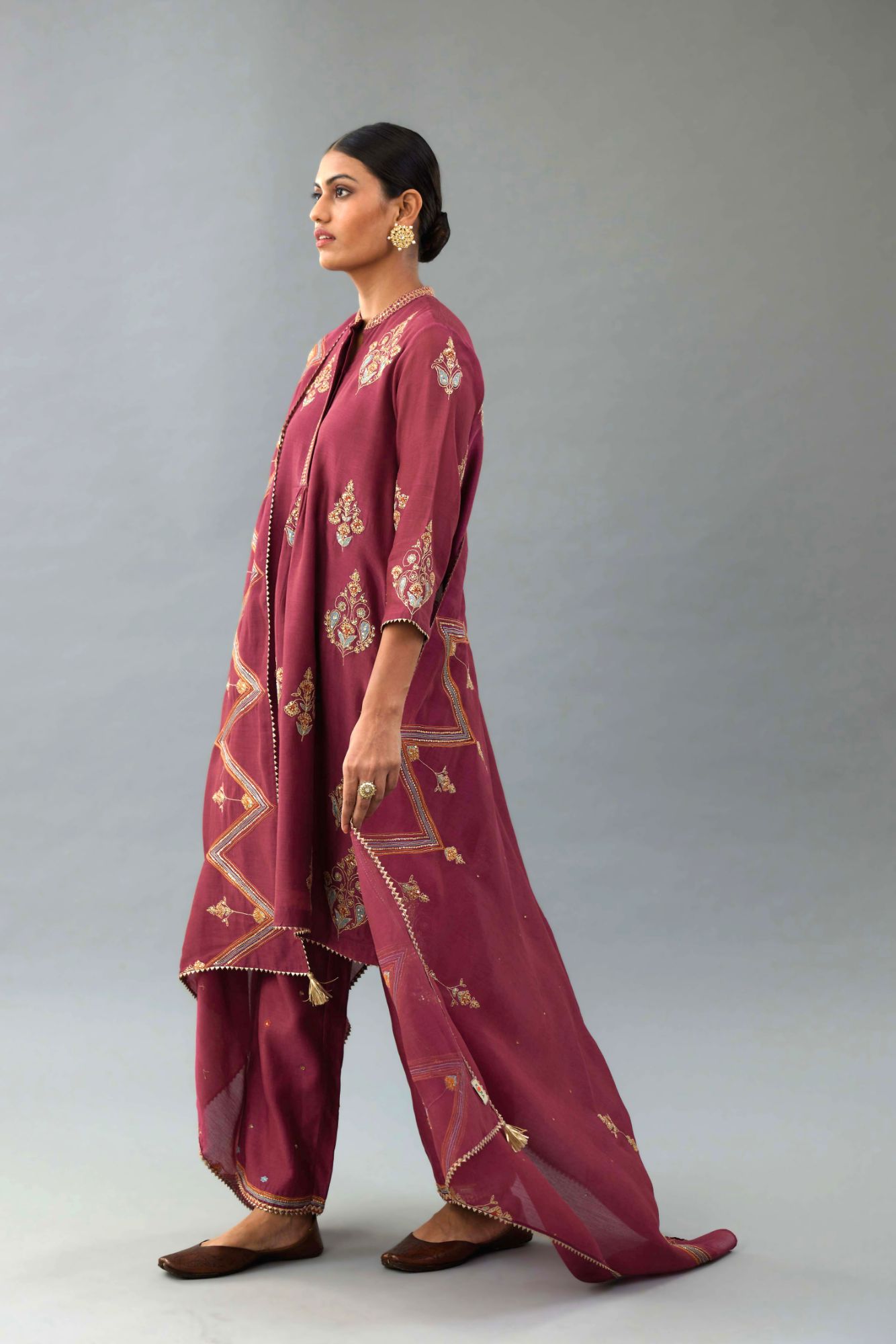 Wine Silk Chanderi short kurta set with collar and front placket, detailed with delicate gold embroidery is done around the placket and collar.