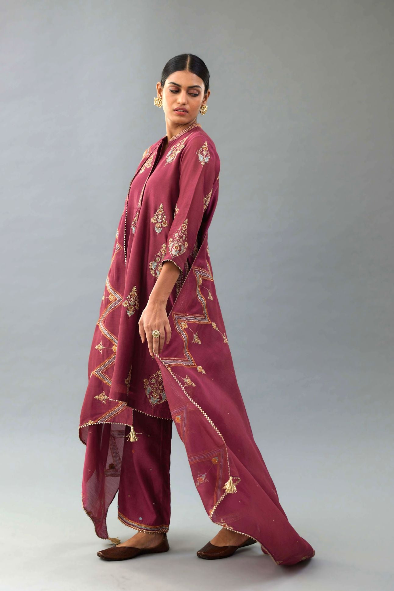 Wine Silk Chanderi short kurta set with collar and front placket, detailed with delicate gold embroidery is done around the placket and collar.