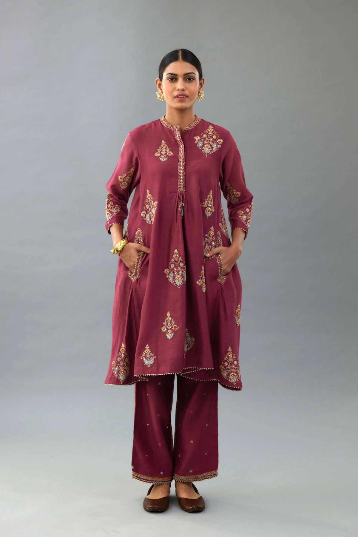 Wine Silk Chanderi short kurta set with collar and front placket, detailed with delicate gold embroidery is done around the placket and collar.