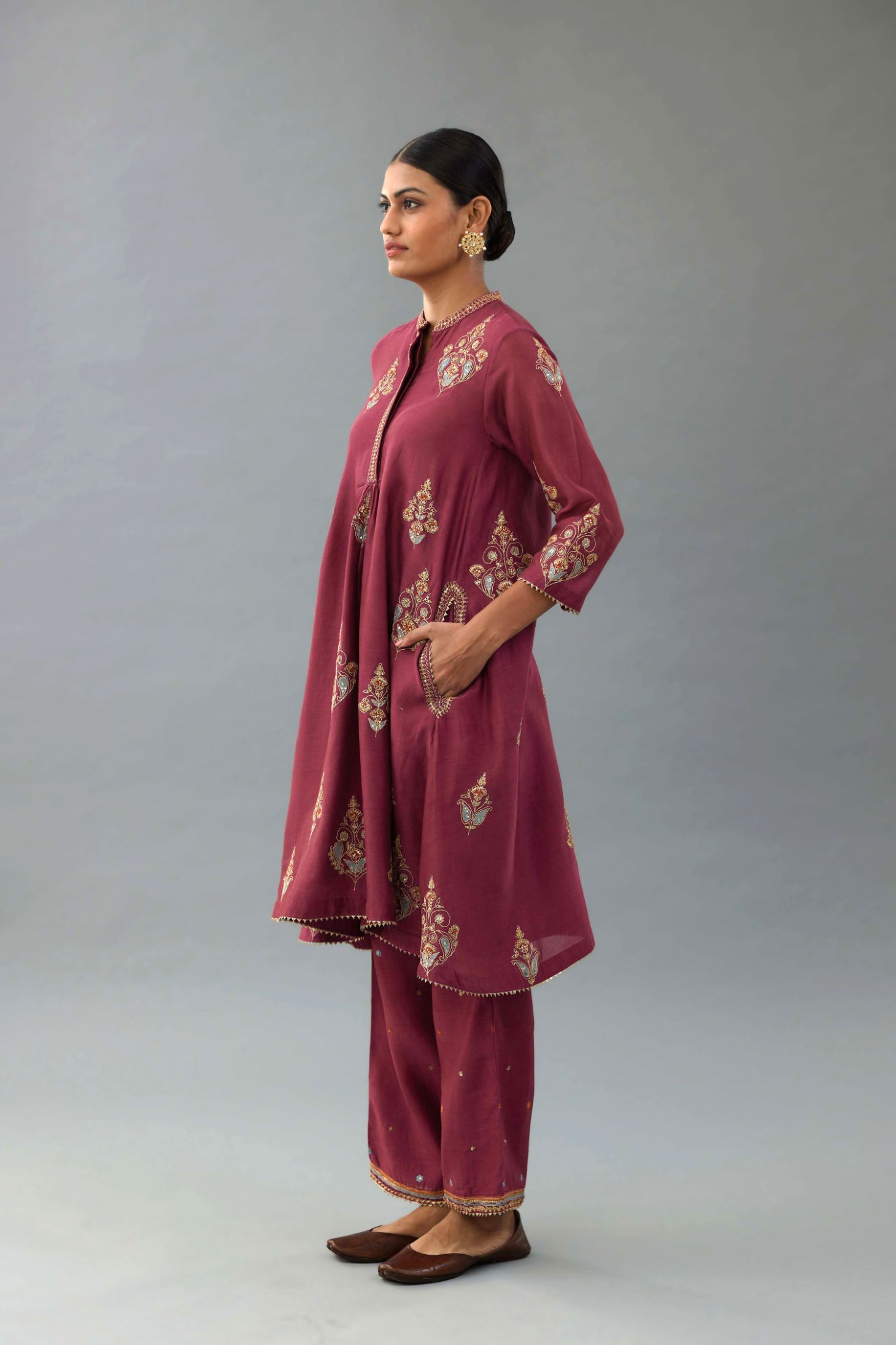 Wine Silk Chanderi short kurta set with collar and front placket, detailed with delicate gold embroidery is done around the placket and collar.