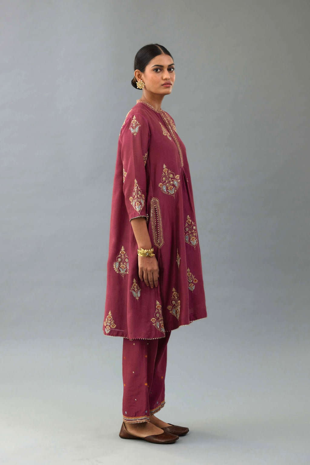 Wine Silk Chanderi short kurta set with collar and front placket, detailed with delicate gold embroidery is done around the placket and collar.