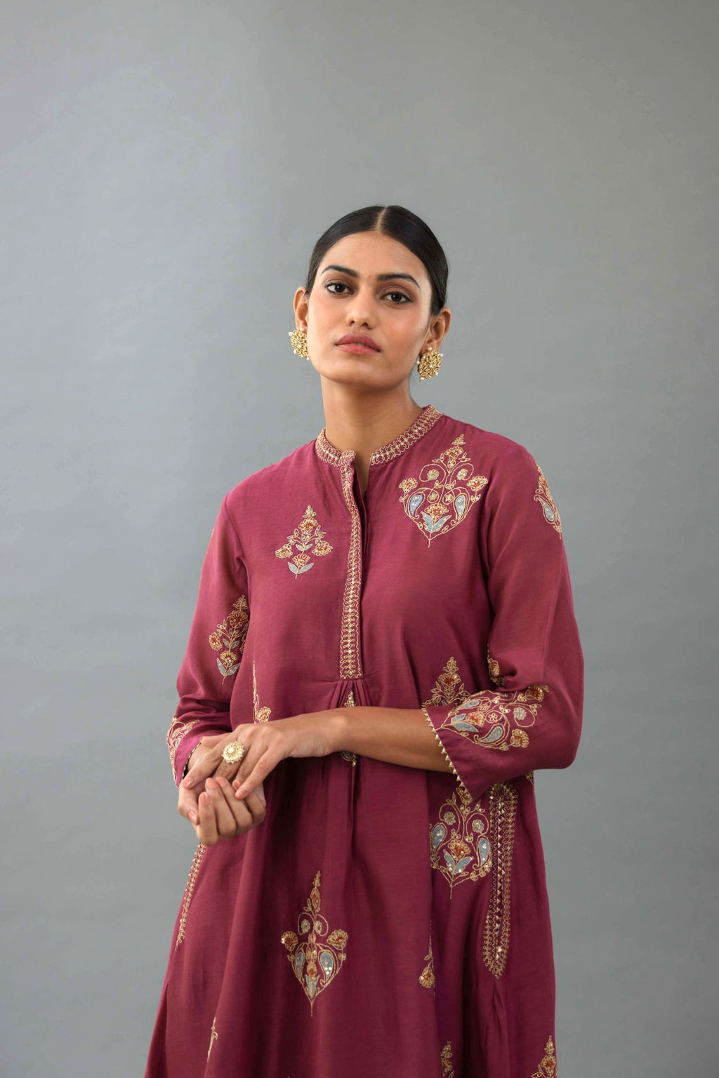 Wine Silk Chanderi short kurta set with collar and front placket, detailed with delicate gold embroidery is done around the placket and collar.