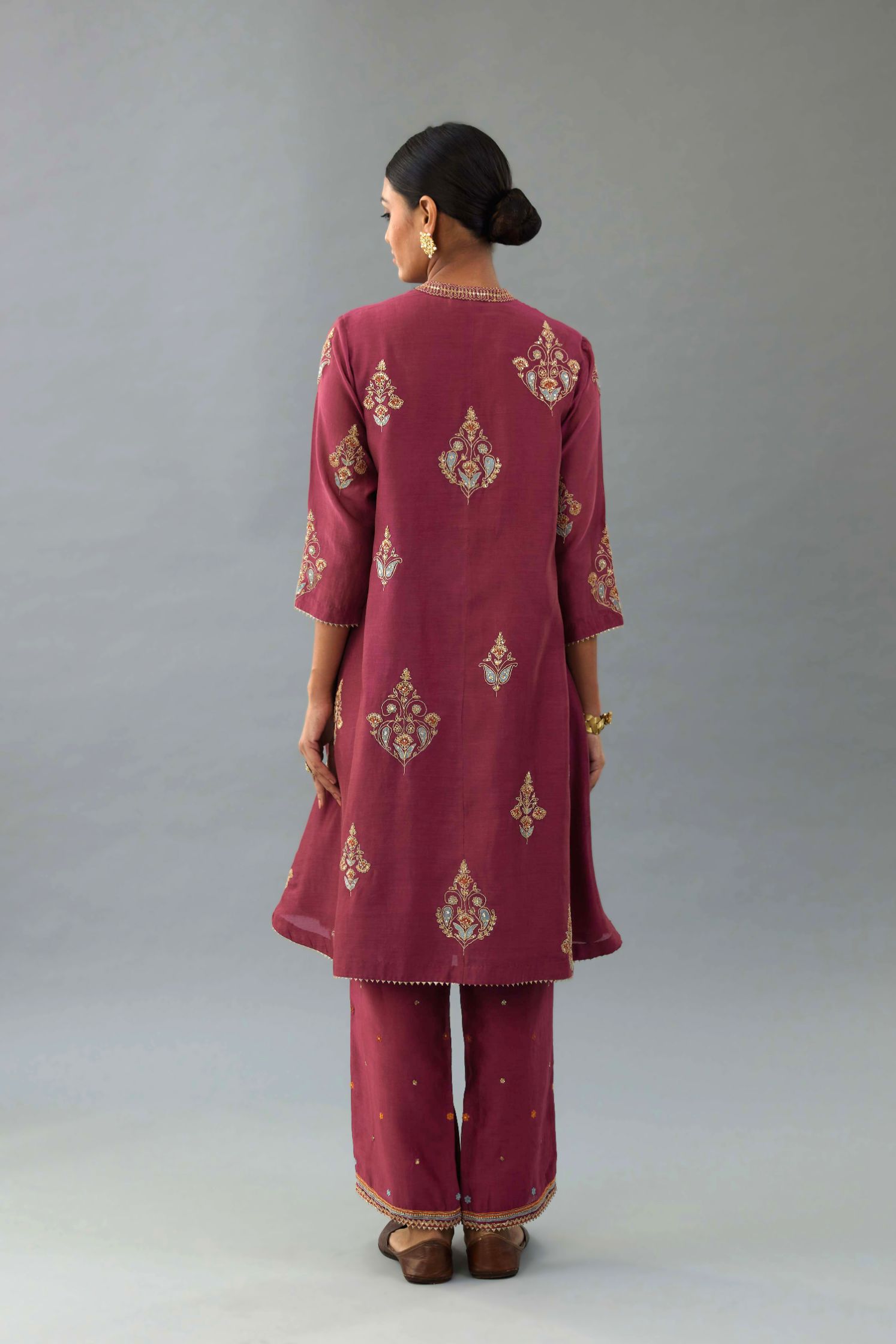 Wine Silk Chanderi short kurta set with collar and front placket, detailed with delicate gold embroidery is done around the placket and collar.
