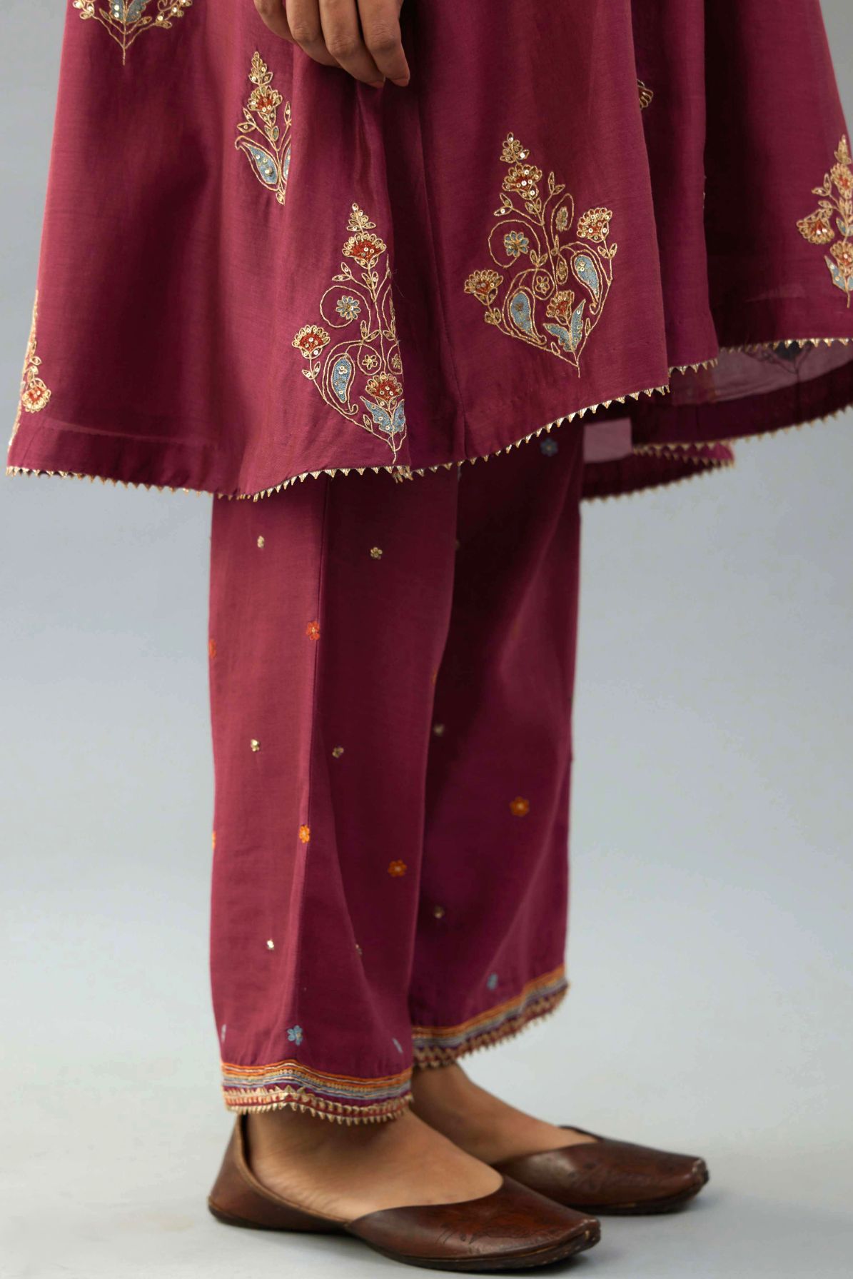 Wine Silk Chanderi short kurta set with collar and front placket, detailed with delicate gold embroidery is done around the placket and collar.