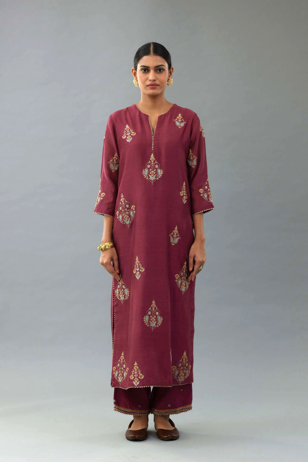 Wine silk chanderi straight kurta set with zari, dori and contrast silk thread embroidered bootas, highlighted with gold sequins work.
