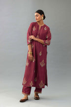 Wine silk chanderi straight kurta set with zari, dori and contrast silk thread embroidered bootas, highlighted with gold sequins work.