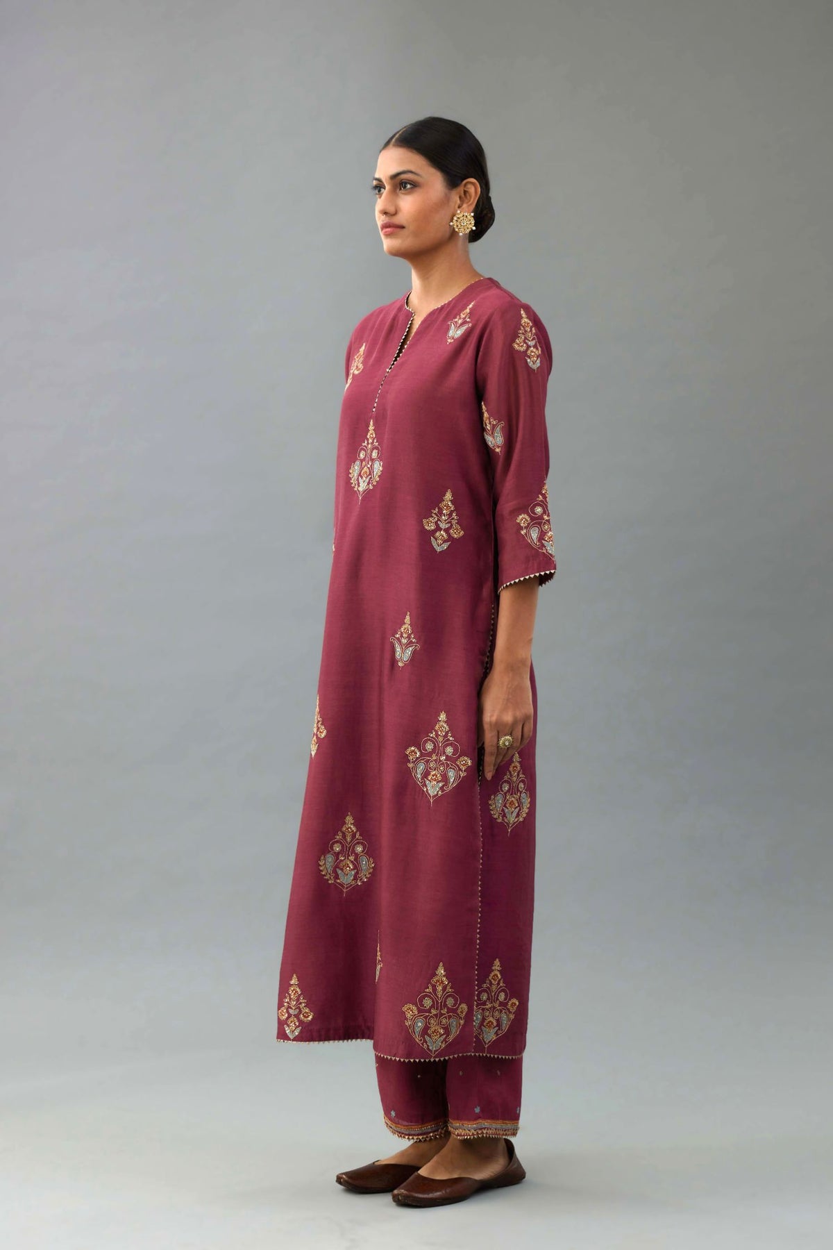 Wine silk chanderi straight kurta set with zari, dori and contrast silk thread embroidered bootas, highlighted with gold sequins work.