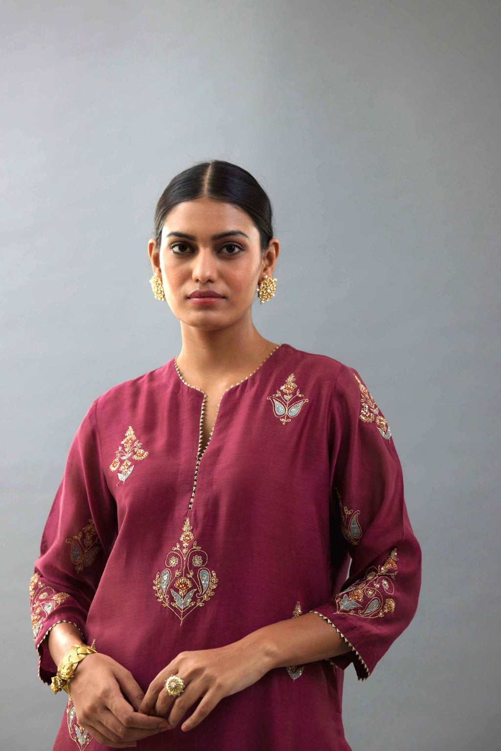 Wine silk chanderi straight kurta set with zari, dori and contrast silk thread embroidered bootas, highlighted with gold sequins work.