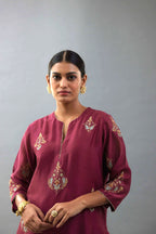Wine silk chanderi straight kurta set with zari, dori and contrast silk thread embroidered bootas, highlighted with gold sequins work.