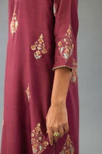 Wine silk chanderi straight kurta set with zari, dori and contrast silk thread embroidered bootas, highlighted with gold sequins work.