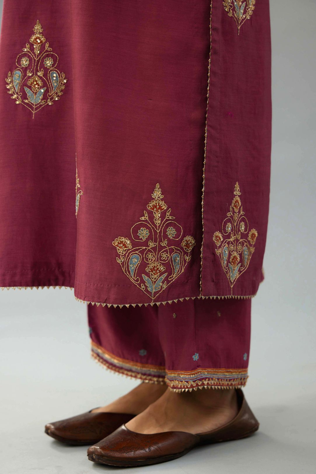 Wine silk chanderi straight kurta set with zari, dori and contrast silk thread embroidered bootas, highlighted with gold sequins work.