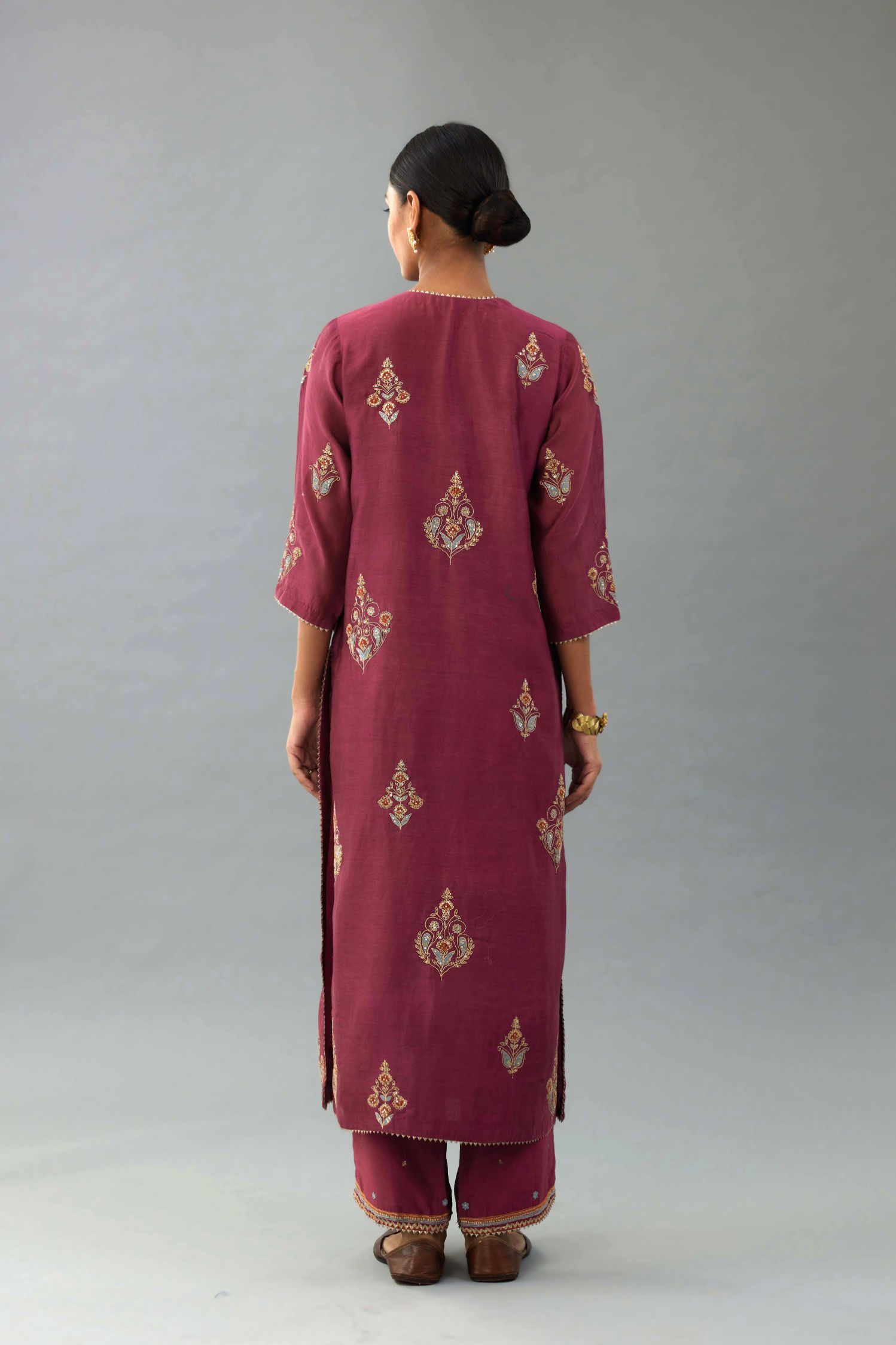 Wine silk chanderi straight kurta set with zari, dori and contrast silk thread embroidered bootas, highlighted with gold sequins work.
