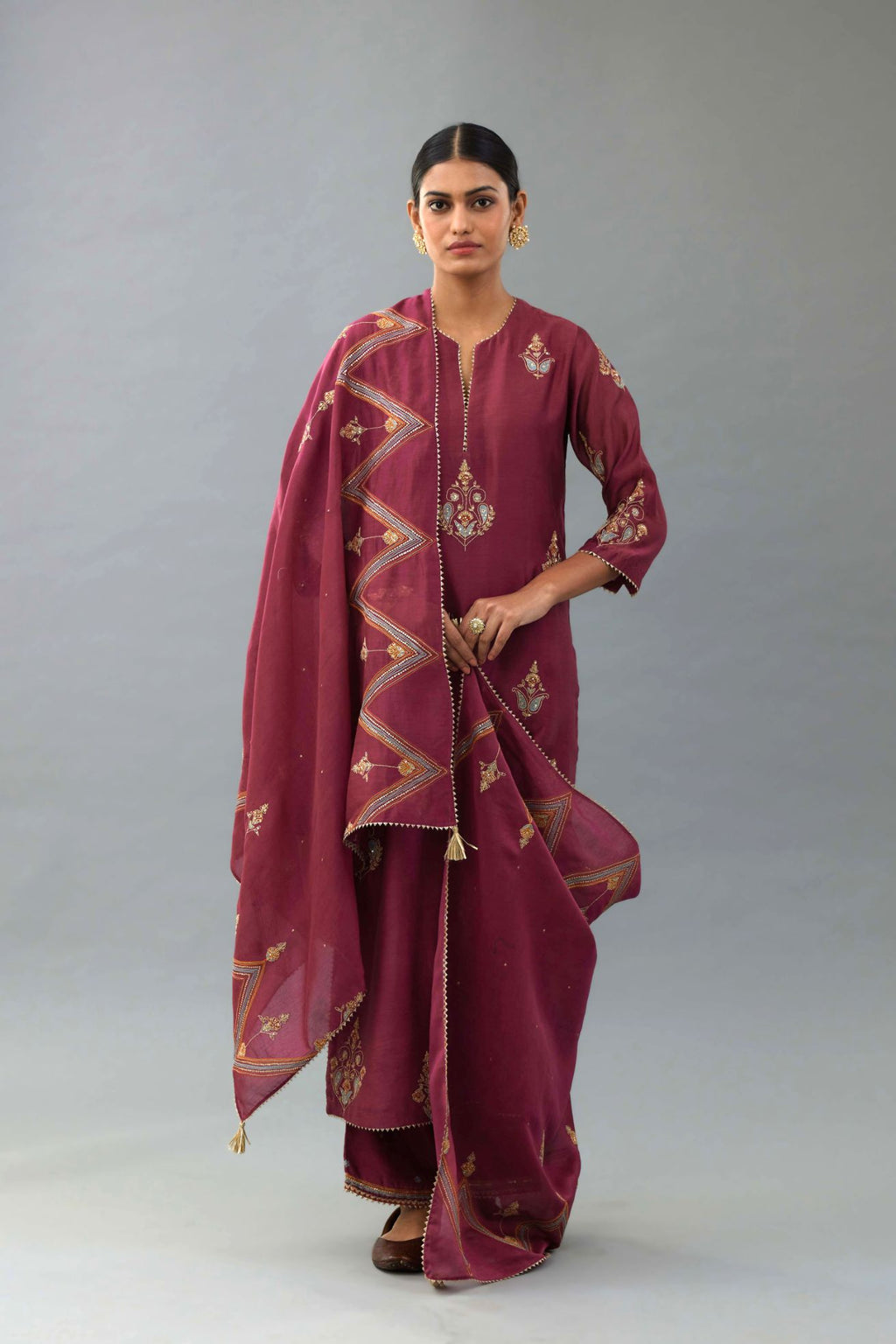 Wine silk chanderi straight kurta set with zari, dori and contrast silk thread embroidered bootas, highlighted with gold sequins work.