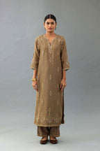 Taupe silk chanderi straight kurta set with all-over zari, dori and contrast silk thread embroidery, highlighted with gold sequins work.