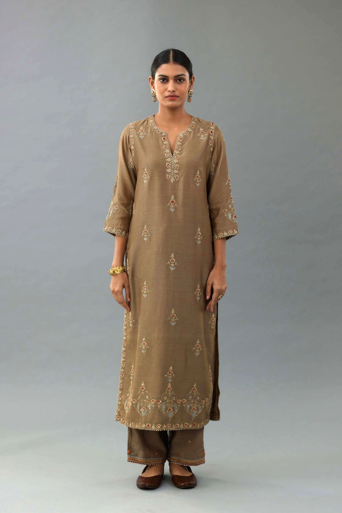 Taupe silk chanderi straight kurta set with all-over zari, dori and contrast silk thread embroidery, highlighted with gold sequins work.