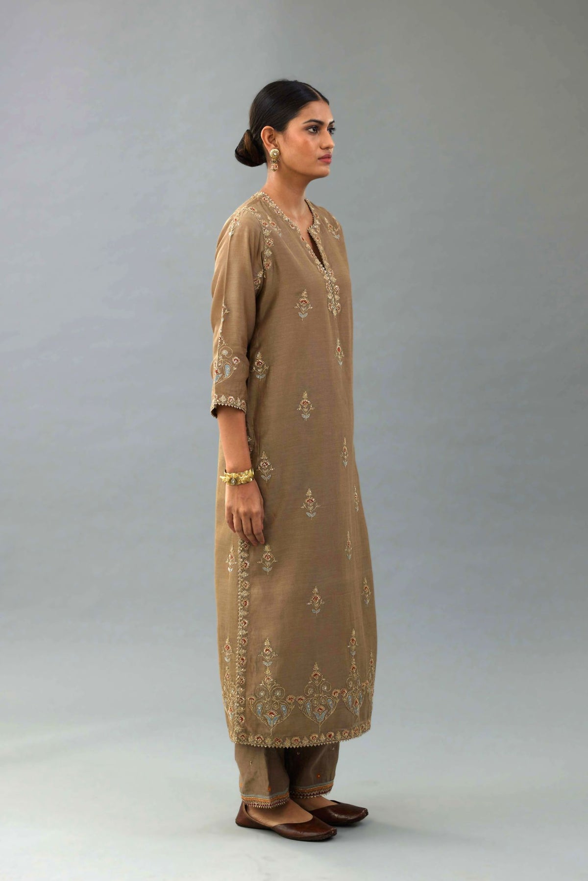 Taupe silk chanderi straight kurta set with all-over zari, dori and contrast silk thread embroidery, highlighted with gold sequins work.