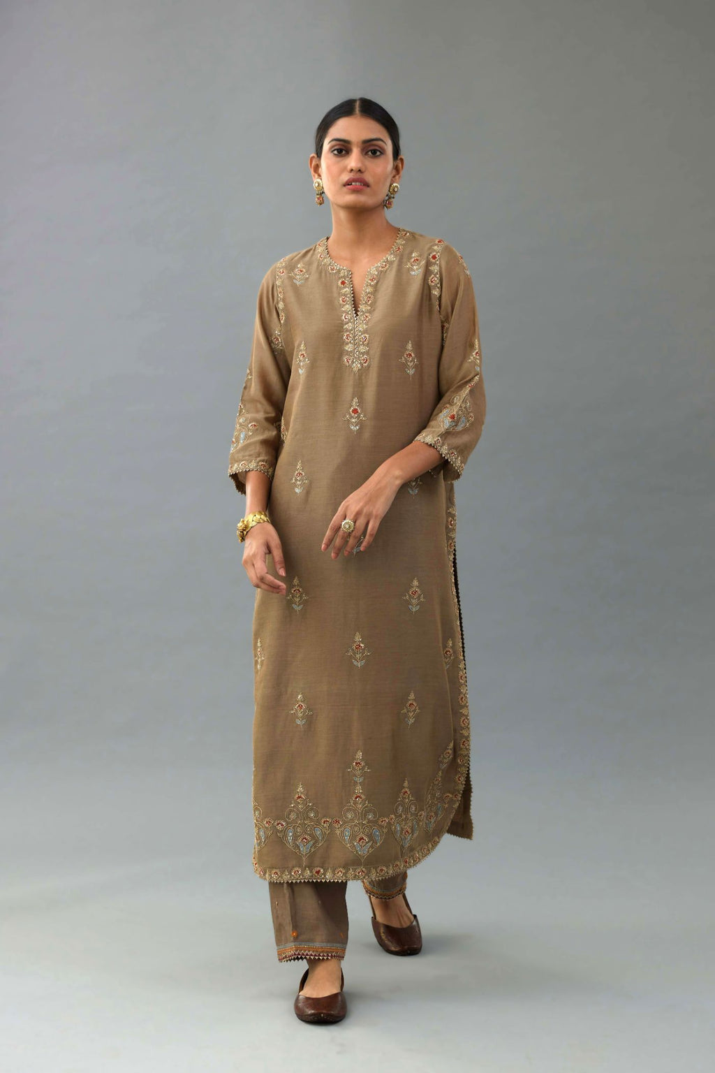 Taupe silk chanderi straight kurta set with all-over zari, dori and contrast silk thread embroidery, highlighted with gold sequins work.