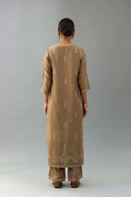 Taupe silk chanderi straight kurta set with all-over zari, dori and contrast silk thread embroidery, highlighted with gold sequins work.