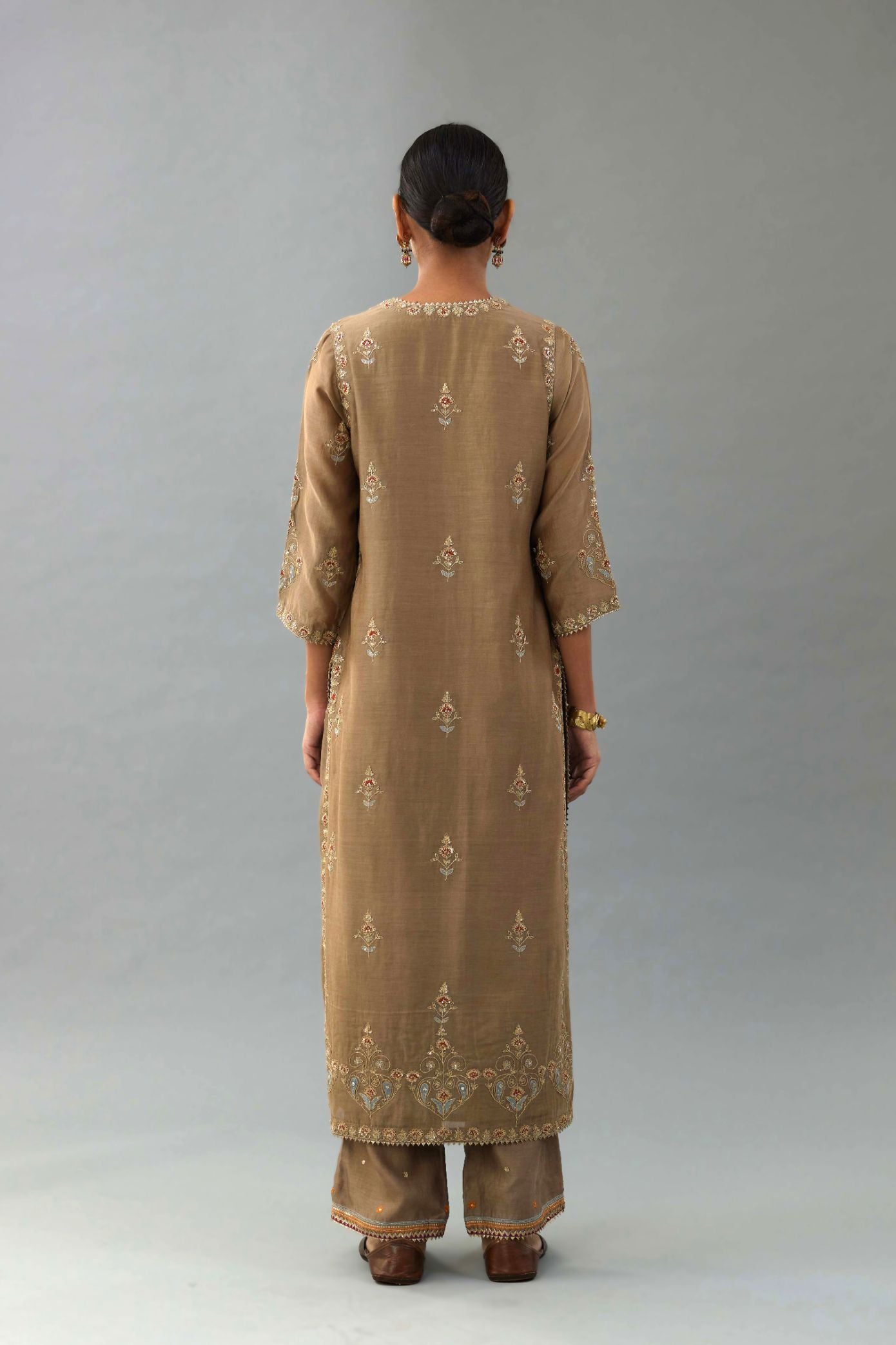 Taupe silk chanderi straight kurta set with all-over zari, dori and contrast silk thread embroidery, highlighted with gold sequins work.