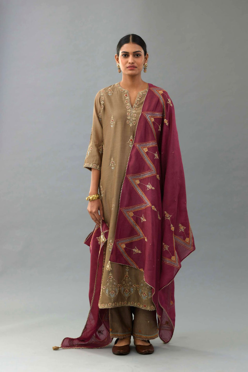 Taupe silk chanderi straight kurta set with all-over zari, dori and contrast silk thread embroidery, highlighted with gold sequins work.