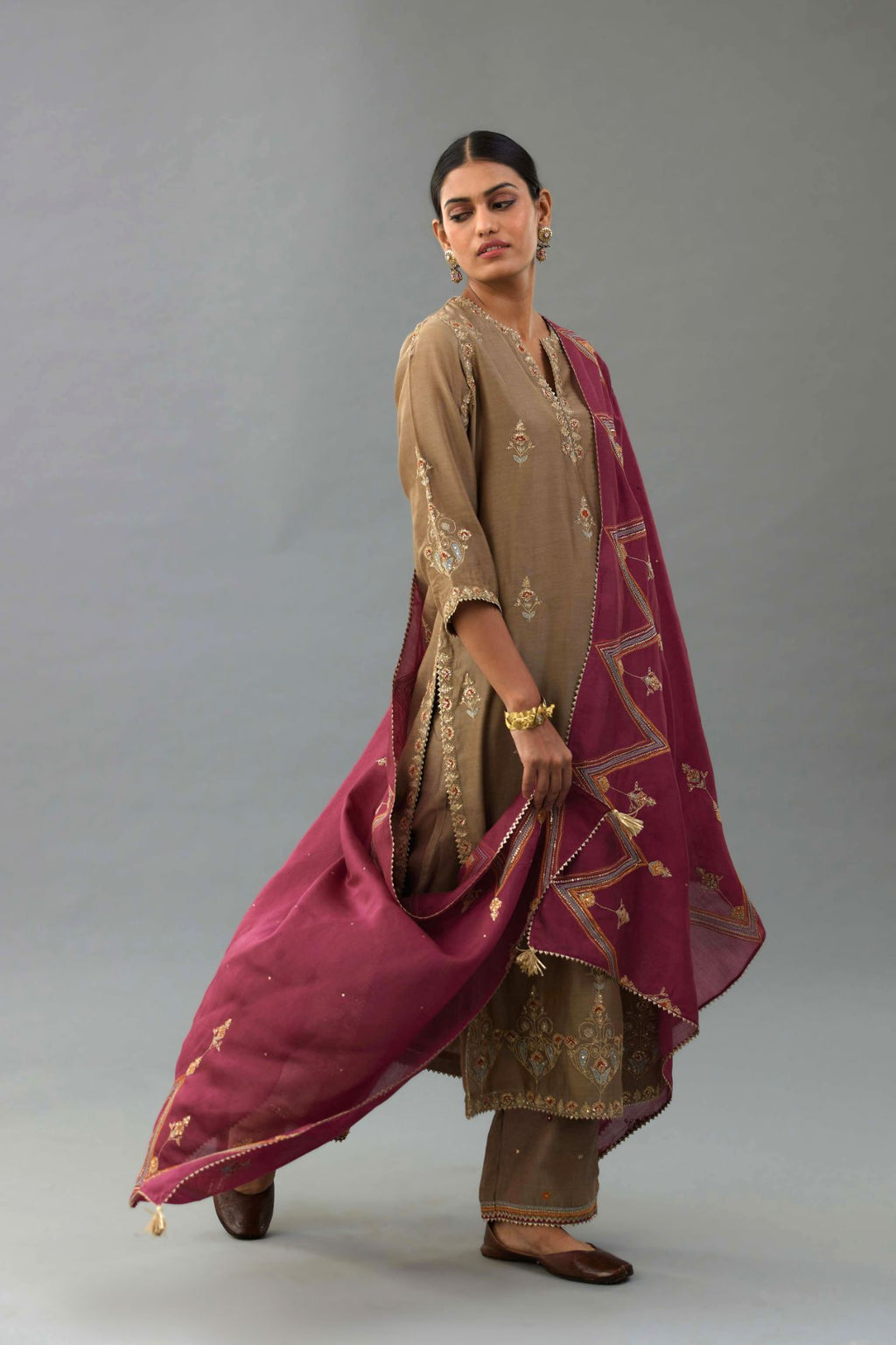 Taupe silk chanderi straight kurta set with all-over zari, dori and contrast silk thread embroidery, highlighted with gold sequins work.
