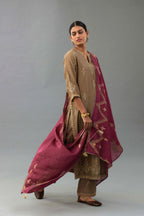 Taupe silk chanderi straight kurta set with all-over zari, dori and contrast silk thread embroidery, highlighted with gold sequins work.