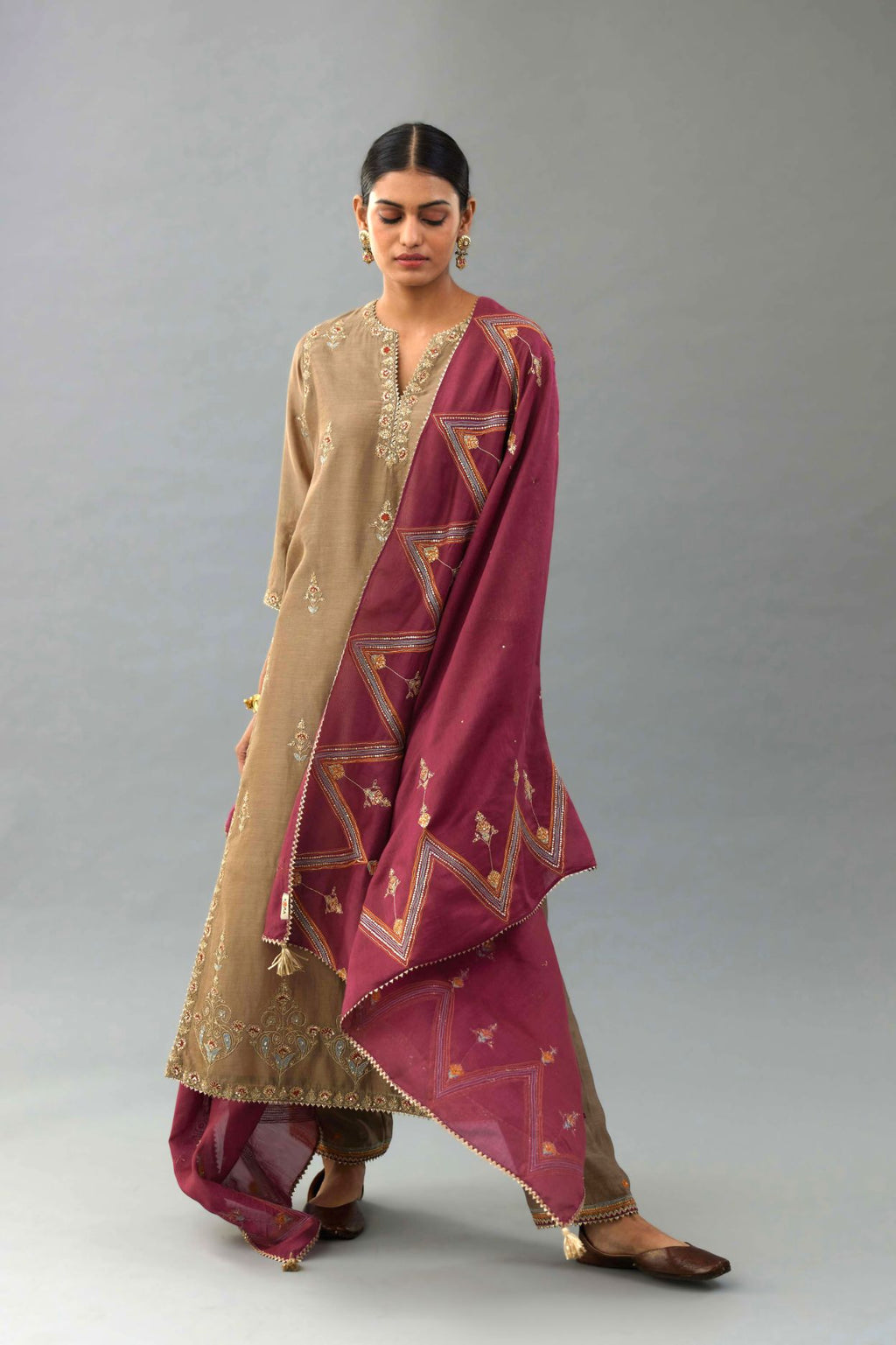 Taupe silk chanderi straight kurta set with all-over zari, dori and contrast silk thread embroidery, highlighted with gold sequins work.