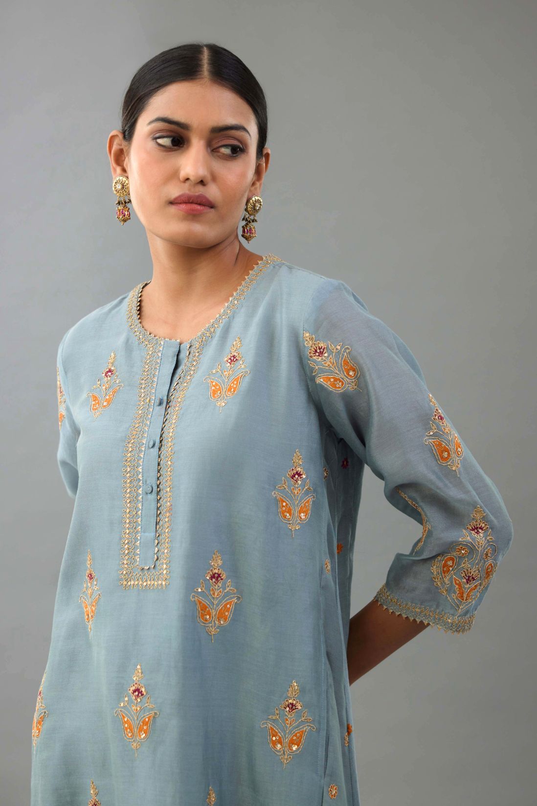 Light blue silk chanderi A-line short kurta set with dori and contrast silk thread embroidery, highlighted with gold sequins work.