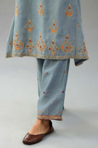 Light blue silk chanderi A-line short kurta set with dori and contrast silk thread embroidery, highlighted with gold sequins work.