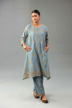Light blue silk chanderi A-line short kurta set with dori and contrast silk thread embroidery, highlighted with gold sequins work.
