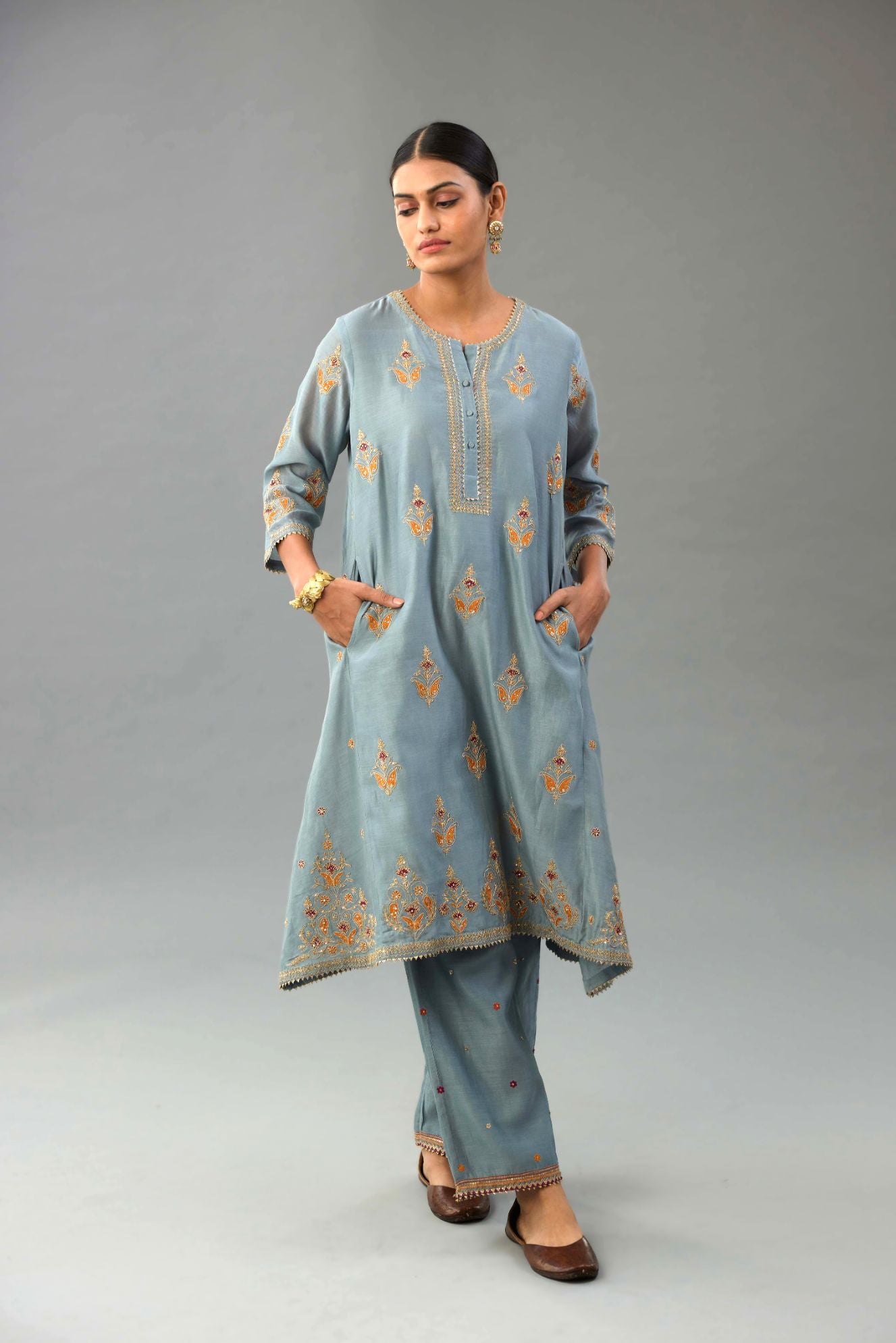 Light blue silk chanderi A-line short kurta set with dori and contrast silk thread embroidery, highlighted with gold sequins work.