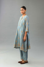 Light blue silk chanderi A-line short kurta set with dori and contrast silk thread embroidery, highlighted with gold sequins work.