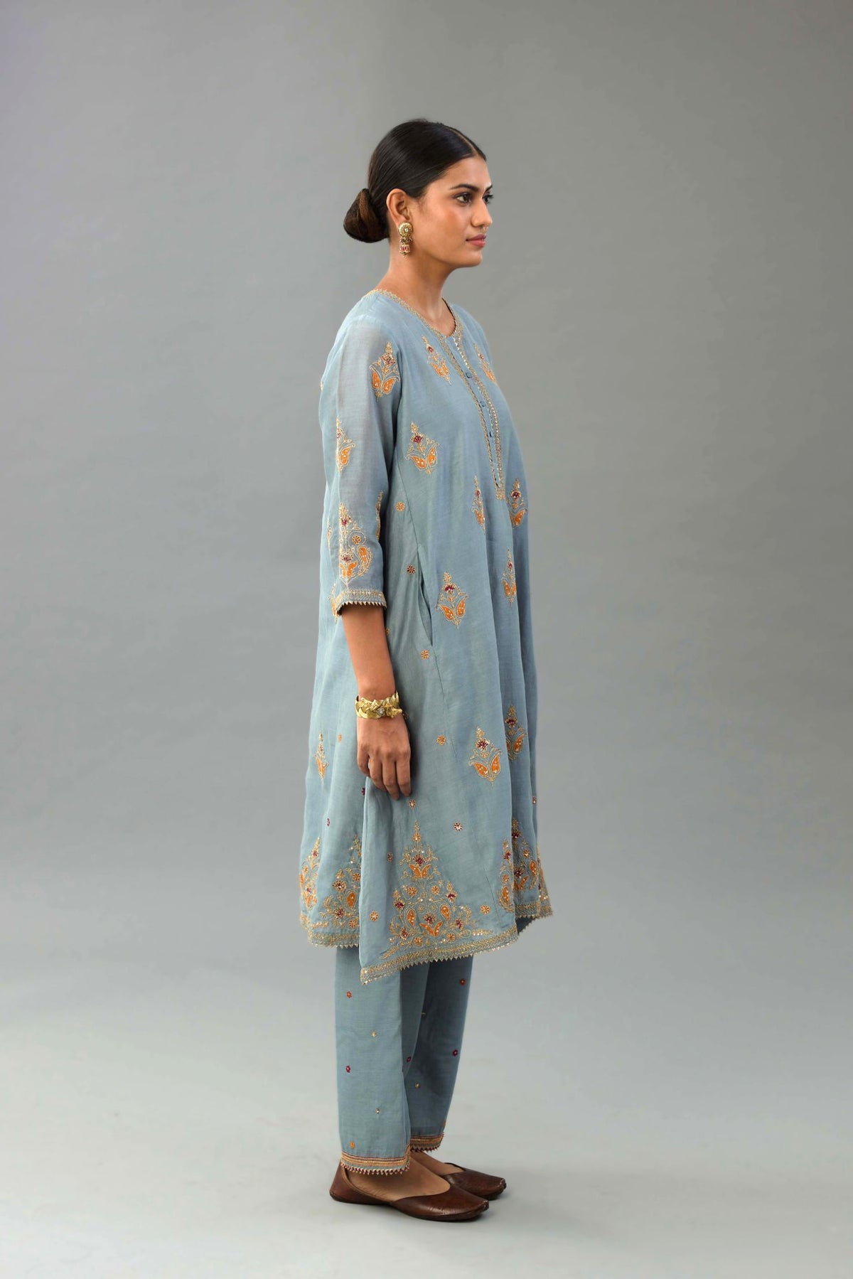 Light blue silk chanderi A-line short kurta set with dori and contrast silk thread embroidery, highlighted with gold sequins work.