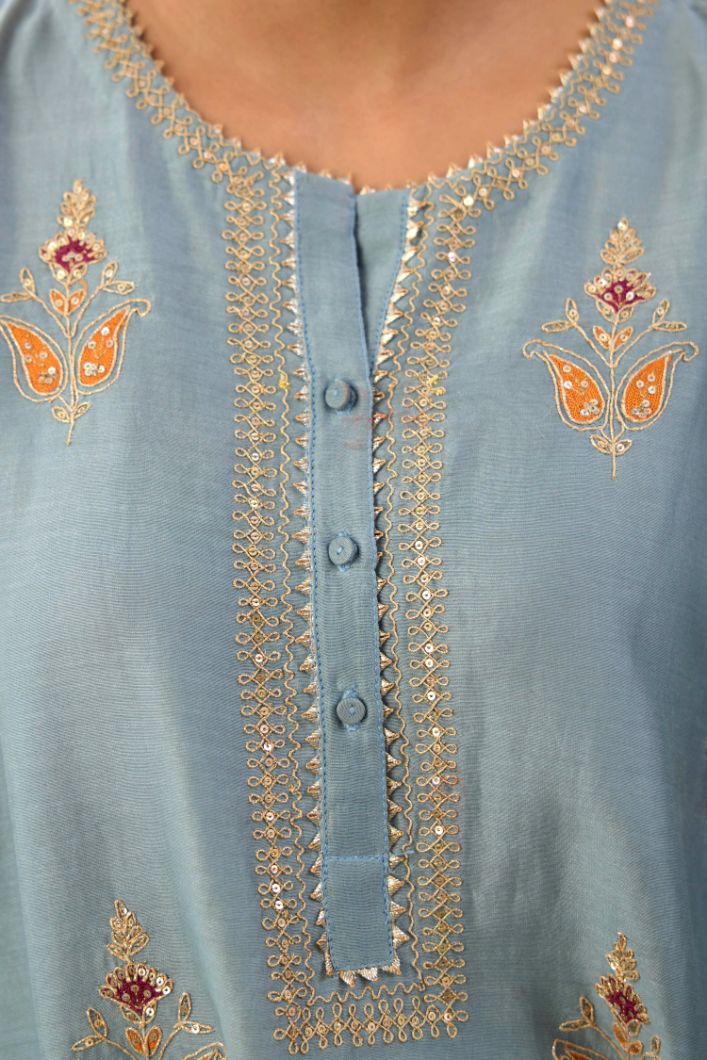 Light blue silk chanderi A-line short kurta set with dori and contrast silk thread embroidery, highlighted with gold sequins work.